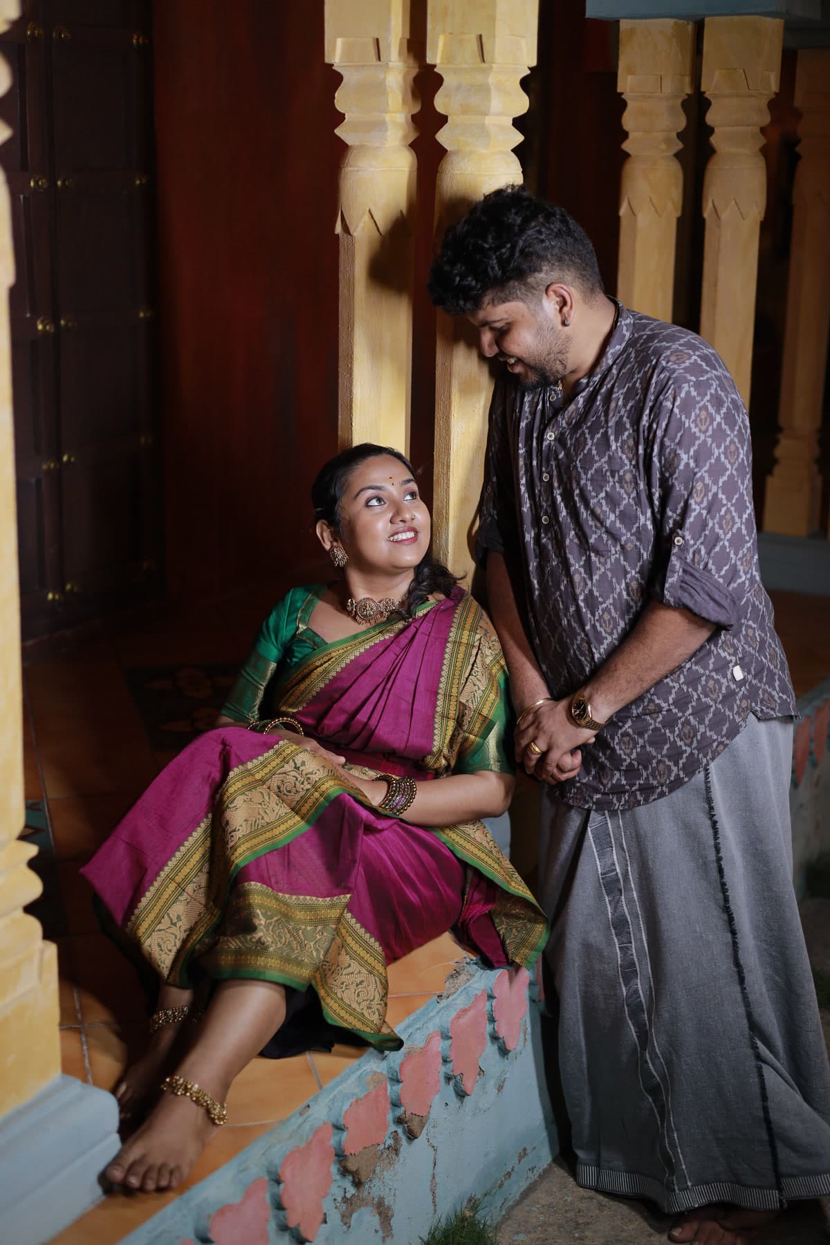 Couple sitting on a raised pillared verandah