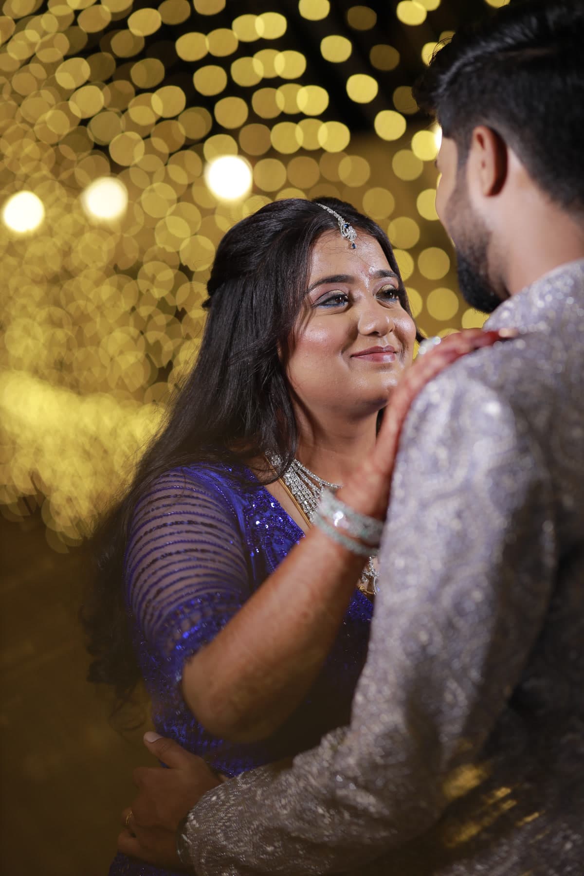 Couple embracing with warm golden background bokeh
